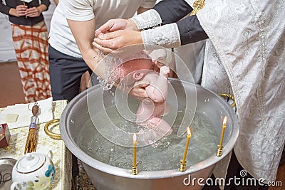 Abbe blessing a little infant kid in baptism christening cerem Stock Photo