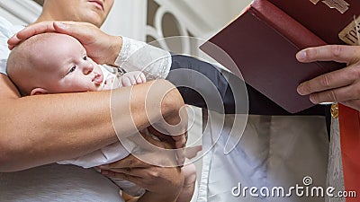 Abbe blessing a little infant kid in baptism christening cerem Stock Photo