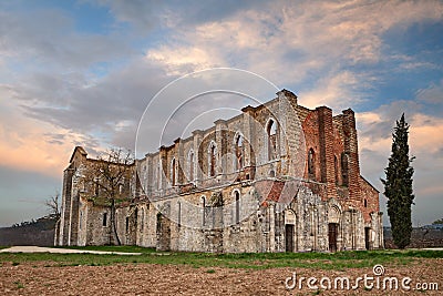 Abbey of Saint Galgano in Chiusdino, Siena, Tuscany, Italy. View at sunset of the medieval roofless church in ruins Stock Photo