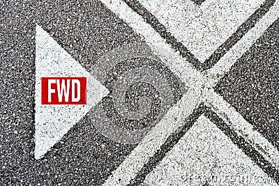 The abbreviation forward fwd written on asphalt road with direction arrows. Moving forward Stock Photo