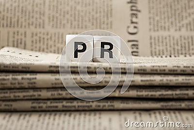 Abbreviation PR on newspapers Stock Photo