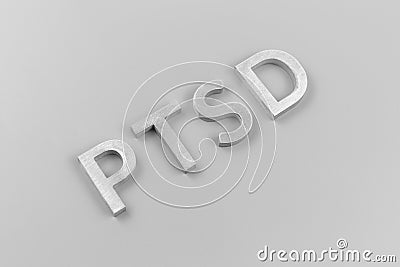 An abbreviation PTSD - post traumatic stress disorder - laid with silver metal letters on light gray flat surface Stock Photo