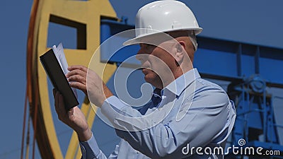 Petroleum Engineer Working in Extracting Oil Industry Using Agenda Stock Photo