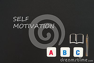 Abc letters and chipboard miniature on blackboard with text self motivation Stock Photo