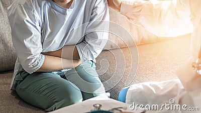 Abdominal pain patient woman having medical exam with doctor on illness from stomach cancer, irritable bowel syndrome Stock Photo