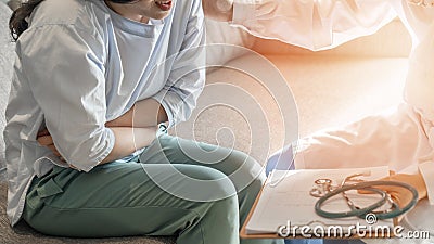 Abdominal pain patient woman having medical exam with doctor on illness from stomach cancer, irritable bowel syndrome Stock Photo