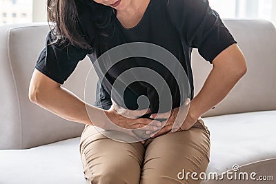 Abdominal pain in woman with stomachache illness from menstruation cramps, stomach cancer, irritable bowel syndrome Stock Photo