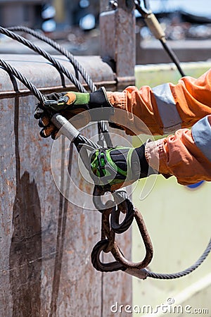 Able seaman is connecting sling. Crane loading operations on dec Stock Photo