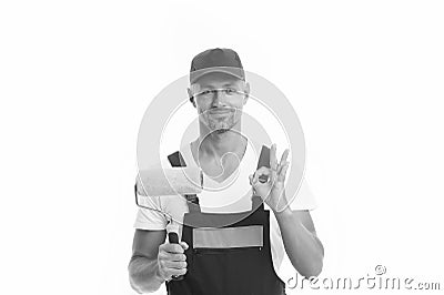 Able to work quickly and accurately. Painter decorator show ok sign isolated on white. Work man hold paint roller Stock Photo