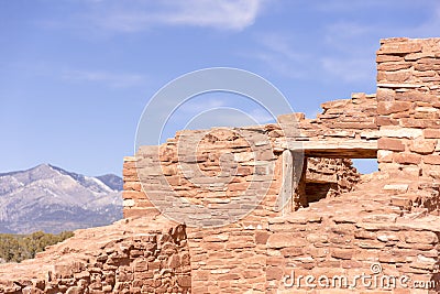 Abo Ruins, New Mexico. Mission wall, window, and Manzano Mountains in the distance. Full sunshine, blue sky Stock Photo