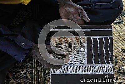 Aboriginal artist creating a dot painting Stock Photo