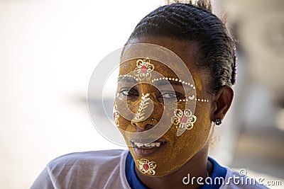 The Aboriginal girls decorate their faces, Amoronia orange coast, Madagascar Editorial Stock Photo