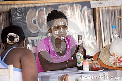 The Aboriginal girls decorate their faces, Amoronia orange coast, Madagascar Editorial Stock Photo