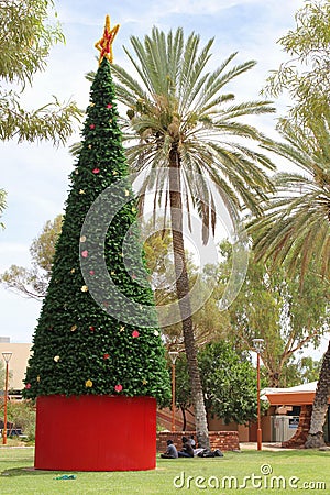 Aboriginals around a decorated Christmas tree in Alice Springs, Australia Editorial Stock Photo