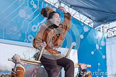 Aborigine female emotional dancing in national clothes indigenous people Kamchatka. Kamchatka Peninsula State Academic Editorial Stock Photo