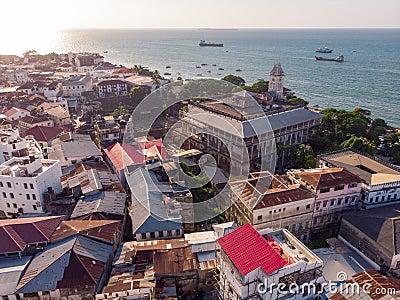 Above the Building Roofs Aerial view of Zanzibar, Stone Town. Tanzania. Sunset Time Coastal City in Africa Stock Photo