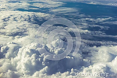 Above heaven concept, view from airplane to fluffy white clouds and blue atmosphere, nature skyline landscape Stock Photo