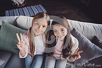 Above high angle view of two nice sweet adorable lovely attractive cheerful cheery girls embracing showing v-sign Stock Photo