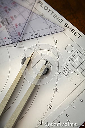 Above image of a navigator's radar plotting chart with a triangle and compass divider Stock Photo