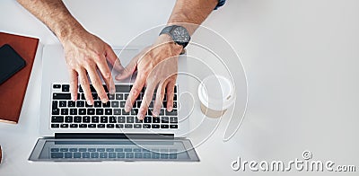 Above, keyboard and laptop by hands of man typing, email or creative article at a desk. Top view, writer and male Stock Photo