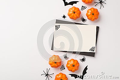 Above photo of white card with black frame and halloween decoration web spiders pumpkin and bats isolated on the white background Stock Photo