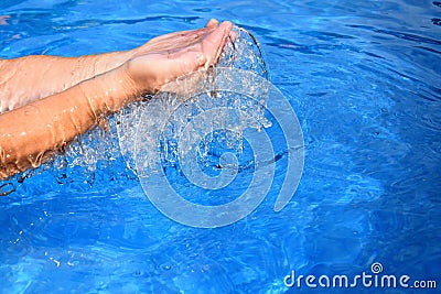 Above the pool of human two hands overflowing water Stock Photo