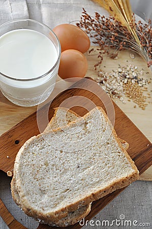 Above Shot of Whole Grain Bread with Milk and Eggs on Background Stock Photo