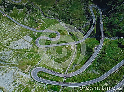 Above view of epic winding road on Transfagarasan pass in Romania in summer time, with twisty road rising up. Road crossing Stock Photo