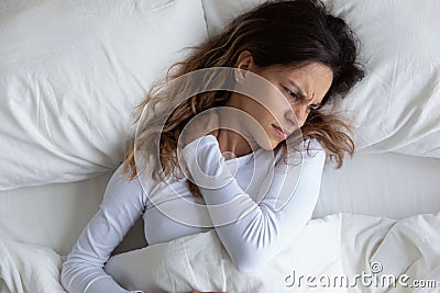 Above view frown woman feels pain in neck Stock Photo