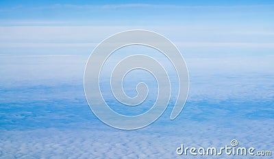 Above view many little clouds in blue sky from airplane Stock Photo