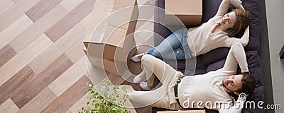 Above view married couple resting on couch at moving day Stock Photo