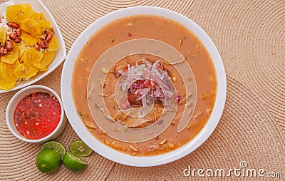 Above view of traditional Ecuadorian food called Encebollado, fish stew and ring onions inside, served with popcorn Stock Photo