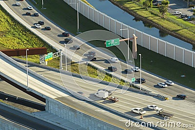 Above view of wide highway crossroads in Miami, Florida with slow driving cars during rush hour. USA transportation Stock Photo