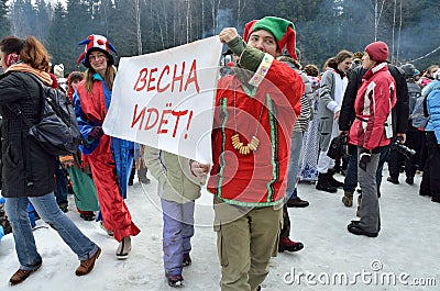 Abramtsevo, Moscow region, Russia, March, 13. 2016. People taking part in celebration of Bakshevskaya Shrovetide near straw effigy Editorial Stock Photo