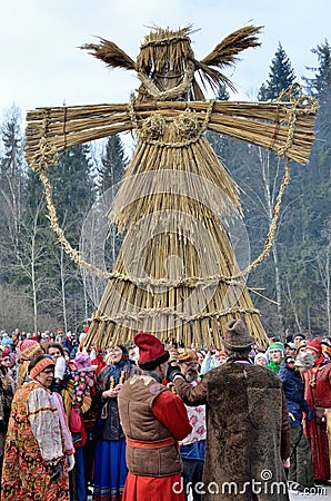 Abramtsevo, Moscow region, Russia, March, 13. 2016. People taking part in celebration of Bakshevskaya Shrovetide near straw effigy Editorial Stock Photo