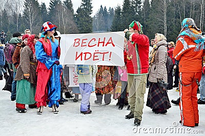 Abramtsevo, Moscow region, Russia, March, 13. 2016. People taking part in celebration of Bakshevskaya Shrovetide near straw effigy Editorial Stock Photo