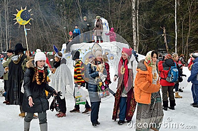 Abramtsevo, Moscow region, Russia, March, 13. 2016. People taking part in celebration of Bakshevskaya Shrovetide near straw effigy Editorial Stock Photo