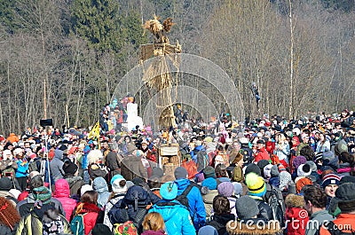 Abramtsevo, Moscow region, Russia, March, 13. 2016. People taking part in celebration of Bakshevskaya Shrovetide near straw effigy Editorial Stock Photo