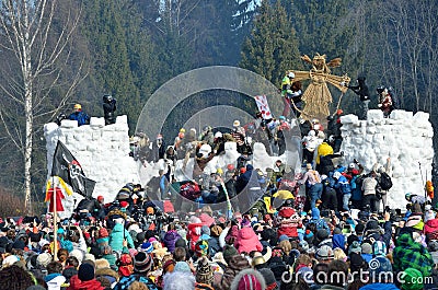 Abramtsevo, Moscow region, Russia, March, 13. 2016. People taking part in celebration of Bakshevskaya Shrovetide. Storming the for Editorial Stock Photo