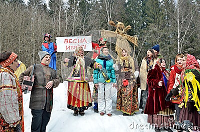 Abramtsevo, Russia, March, 13. 2016. People taking part in celebration of Bakshevskaya Shrovetide near straw effigy Editorial Stock Photo