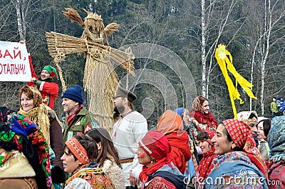 Abramtsevo, Russia, March, 13. 2016. People taking part in celebration of Bakshevskaya Shrovetide near straw effigy Editorial Stock Photo