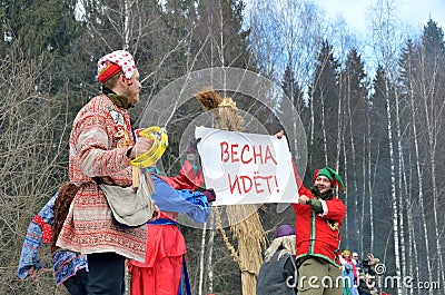 Abramtsevo, Russia, March, 13. 2016. People taking part in celebration of Bakshevskaya Shrovetide near straw effigy Editorial Stock Photo