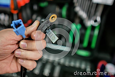 ABS sensor in the hands of an auto mechanic. Stock Photo