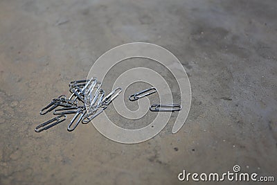 Paper clips lay down at cement path Stock Photo