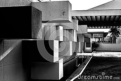 Abstract architecture made of concrete with square blocks sticking out of the wall Stock Photo