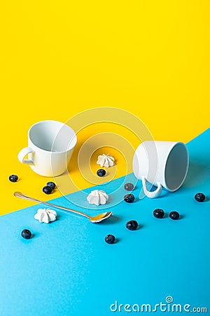 Abstract arrangement with food and different objects on yellow and blue Stock Photo