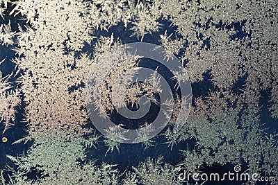 It is a pattern of frost on the glass of a window. White textured frosty crystal snowflake. Natural frost floral pattern with abst Stock Photo