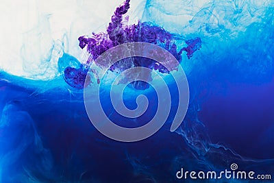 abstract background with blue and purple paint flowing in water Stock Photo