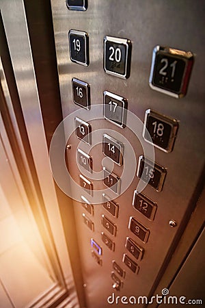 Abstract background of buttons on an elevator panel with button for visually impaired with sunlight in skyscraper Stock Photo