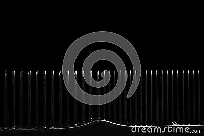 Abstract background with macro comb on black background Stock Photo